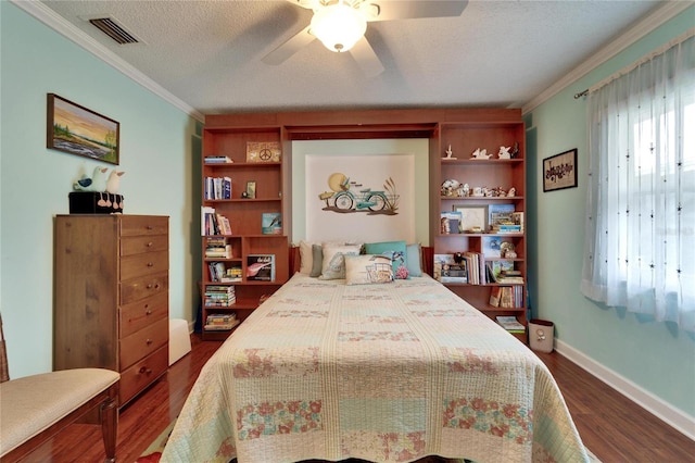 bedroom with multiple windows, dark wood-style floors, visible vents, and a textured ceiling