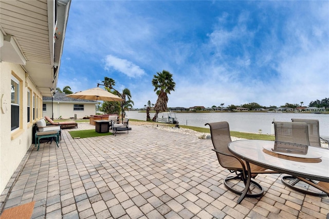 view of patio / terrace featuring outdoor dining space and a water view