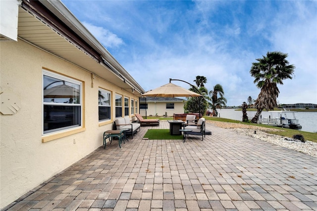 view of patio with a water view