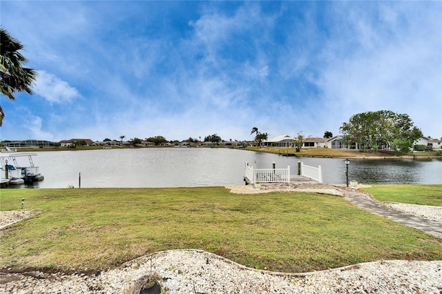 view of dock featuring a water view and a lawn