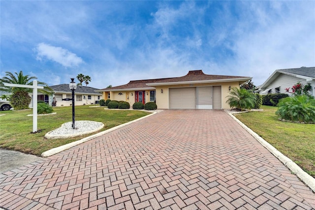 ranch-style house featuring a front lawn, decorative driveway, an attached garage, and stucco siding