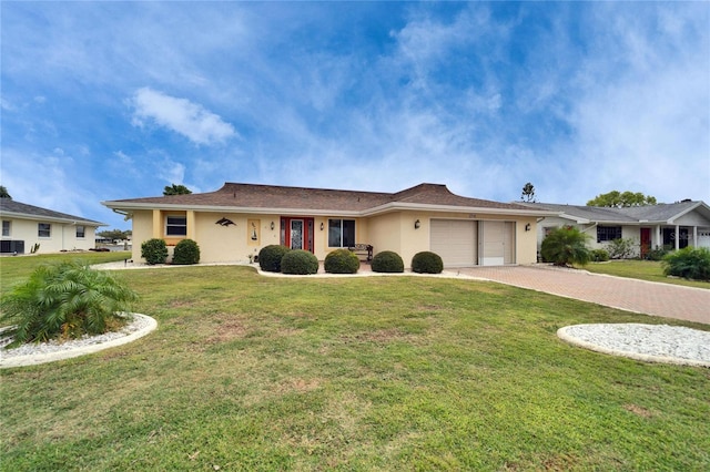 single story home featuring a front yard, decorative driveway, a garage, and stucco siding