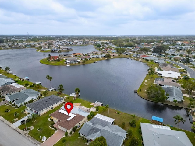 drone / aerial view featuring a residential view and a water view