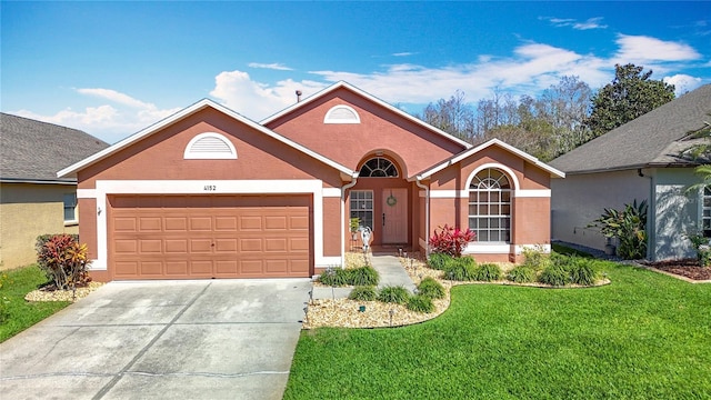 single story home featuring a front lawn, concrete driveway, and stucco siding