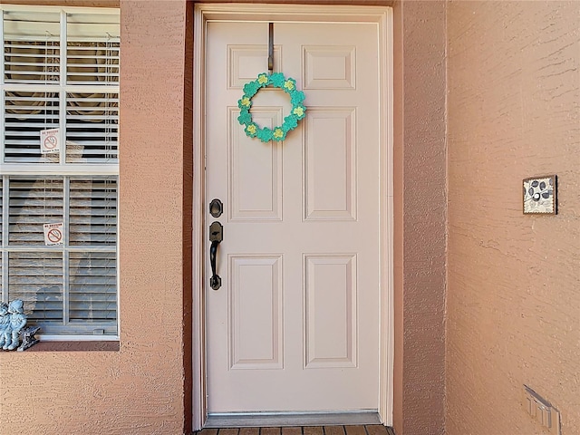 doorway to property with stucco siding