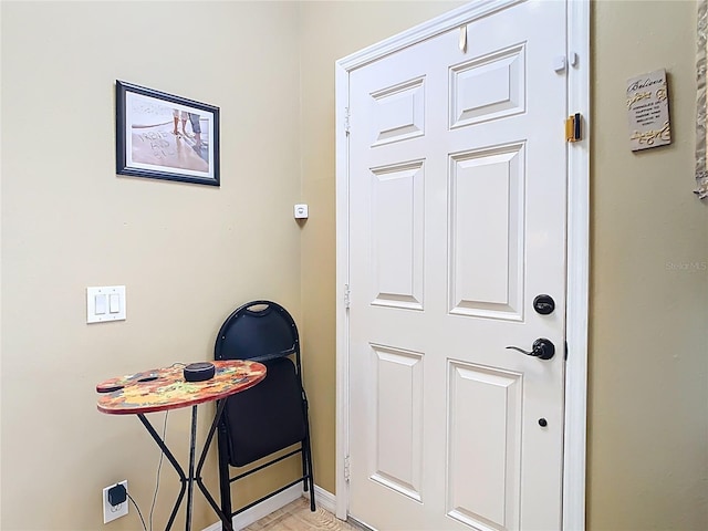 doorway featuring baseboards