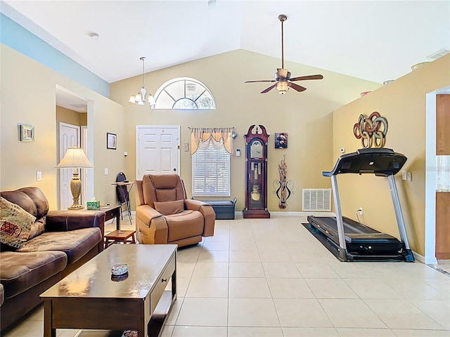 workout area with visible vents, baseboards, high vaulted ceiling, light tile patterned flooring, and ceiling fan with notable chandelier