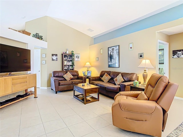 living room with light tile patterned floors, baseboards, visible vents, and high vaulted ceiling