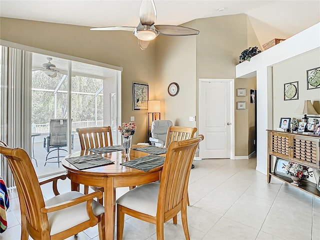 dining area with light tile patterned floors, a ceiling fan, baseboards, high vaulted ceiling, and a sunroom