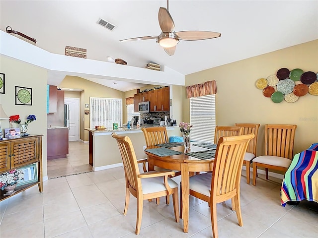 dining area featuring visible vents, a healthy amount of sunlight, ceiling fan, and vaulted ceiling