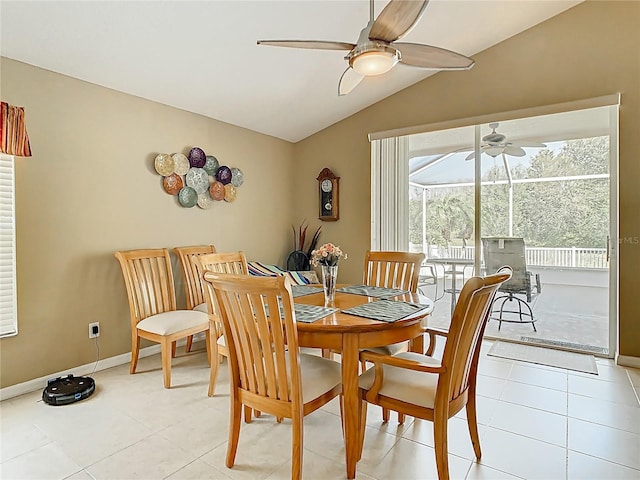 dining space featuring light tile patterned floors, baseboards, lofted ceiling, and ceiling fan