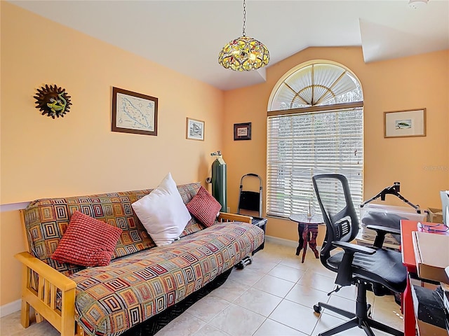 office space featuring light tile patterned floors, plenty of natural light, baseboards, and vaulted ceiling