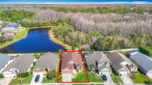 birds eye view of property with a forest view, a residential view, and a water view