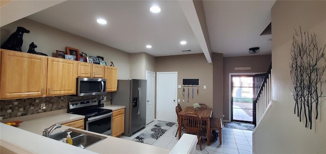 kitchen featuring visible vents, decorative backsplash, appliances with stainless steel finishes, light countertops, and a sink