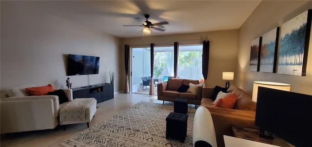 living area with light tile patterned floors and a ceiling fan