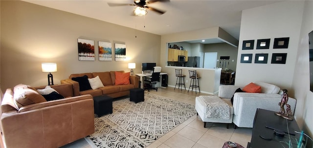 living area featuring a ceiling fan and light tile patterned floors