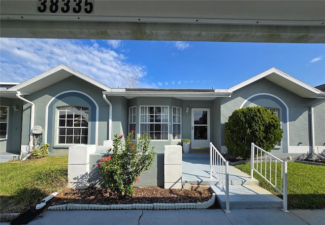 single story home with stucco siding