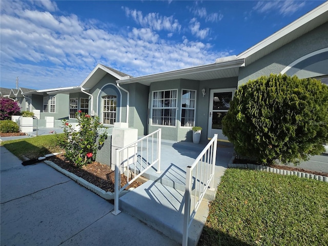 view of front of property with stucco siding and covered porch