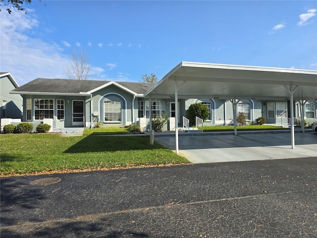 exterior space featuring a front lawn, a carport, and stucco siding