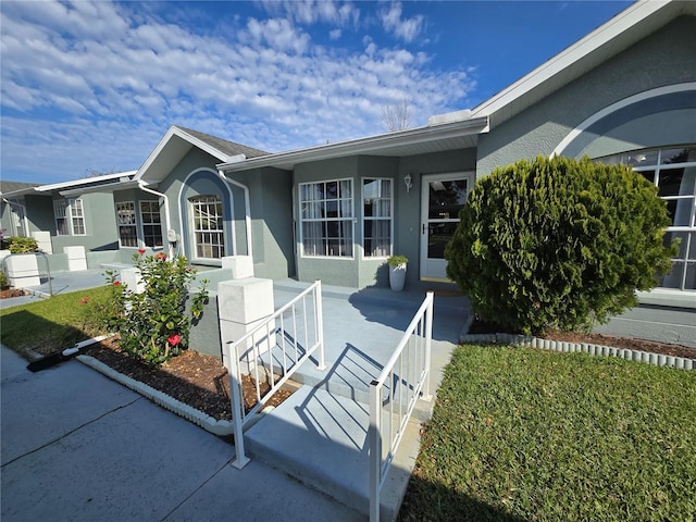 view of front of property with stucco siding and covered porch