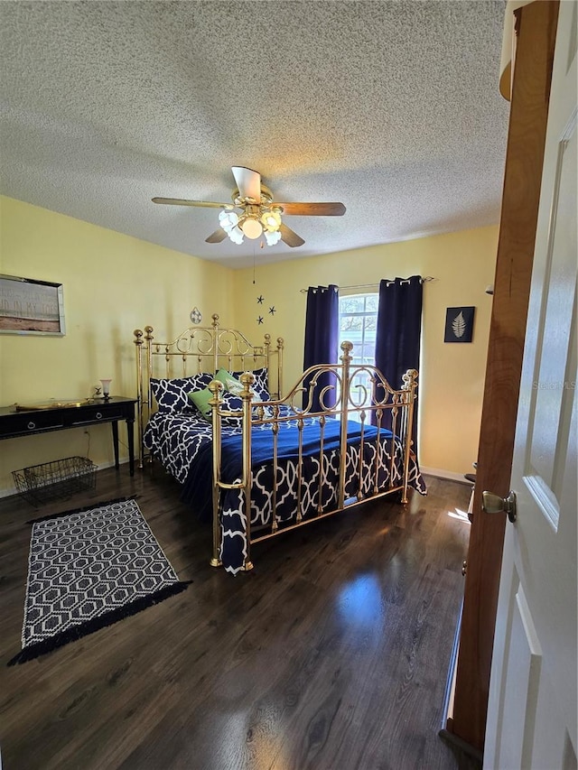 bedroom featuring a textured ceiling, ceiling fan, and wood finished floors