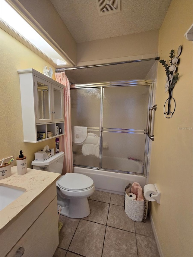 full bathroom with tile patterned floors, visible vents, a textured ceiling, bath / shower combo with glass door, and vanity