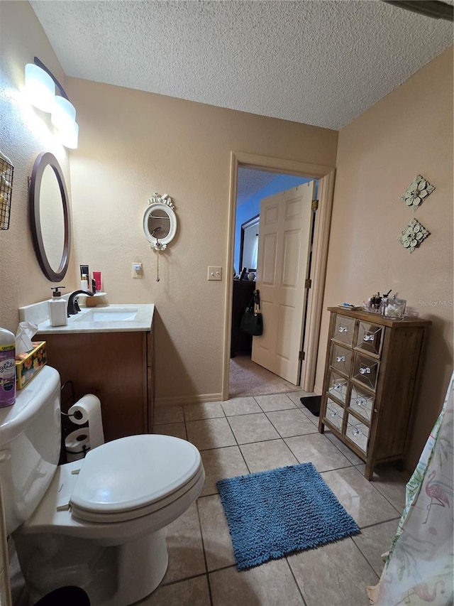 bathroom featuring vanity, toilet, and a textured ceiling