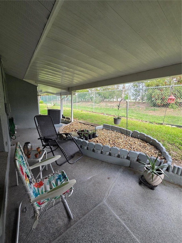 view of patio with cooling unit and fence