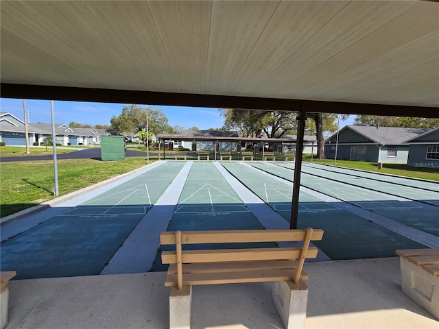 view of home's community with a residential view, shuffleboard, and a yard