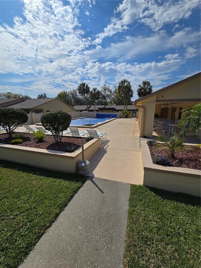 exterior space featuring a swimming pool and a patio area