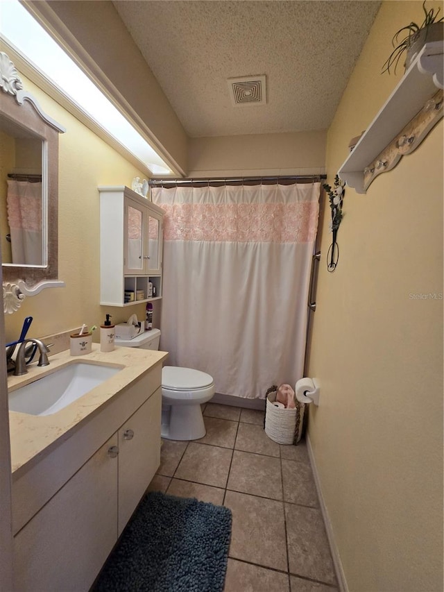 full bath featuring vanity, visible vents, a textured ceiling, tile patterned floors, and toilet