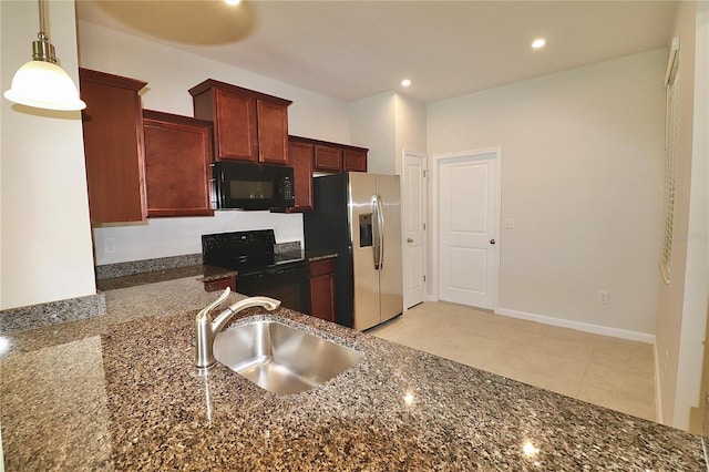 kitchen with baseboards, recessed lighting, a sink, black appliances, and decorative light fixtures