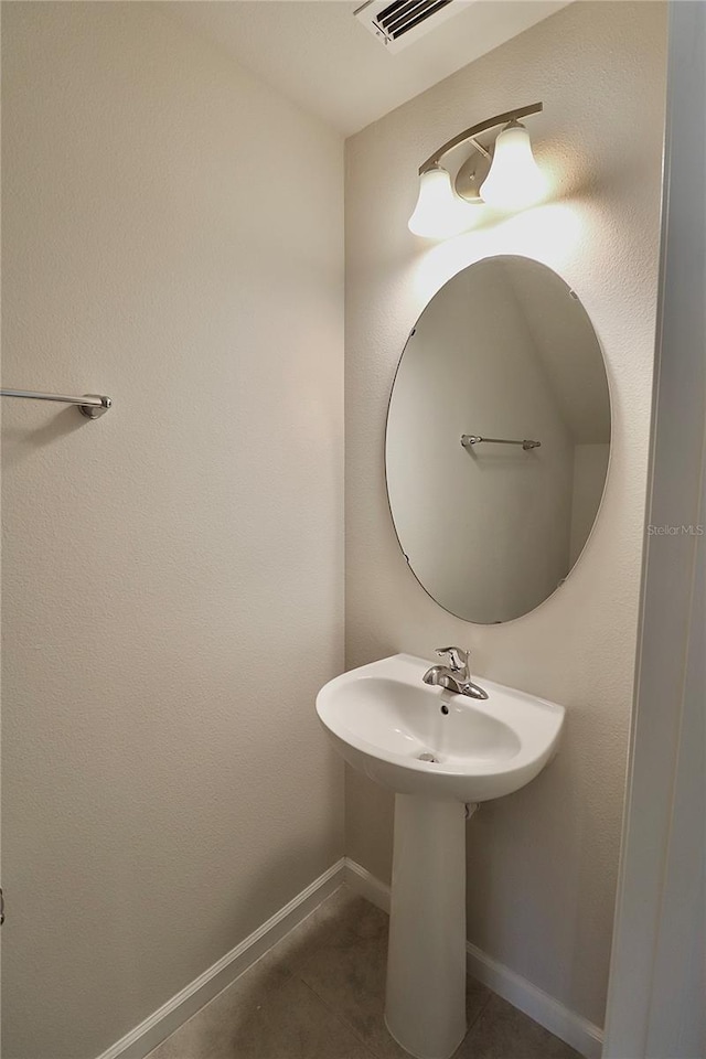 bathroom featuring tile patterned floors, baseboards, and visible vents