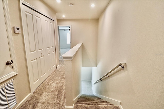 stairs with recessed lighting, visible vents, carpet floors, and baseboards