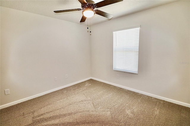 unfurnished room featuring carpet flooring, ceiling fan, a textured ceiling, and baseboards