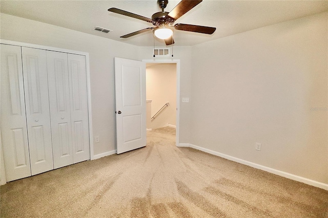 unfurnished bedroom with carpet, visible vents, a closet, and baseboards