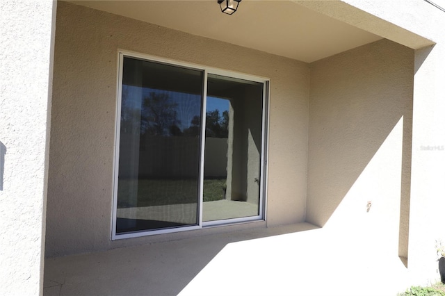 doorway to property with stucco siding