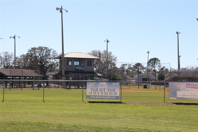 view of home's community with a lawn and fence