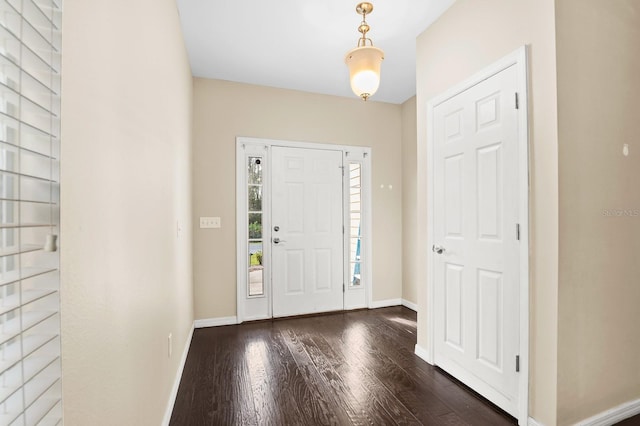 foyer entrance featuring wood finished floors and baseboards