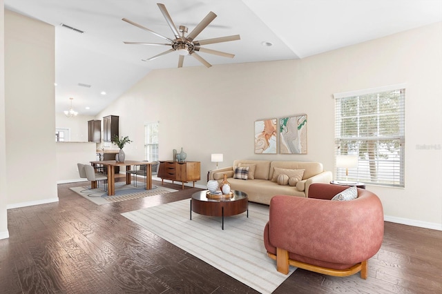 living area with visible vents, lofted ceiling, baseboards, and hardwood / wood-style floors