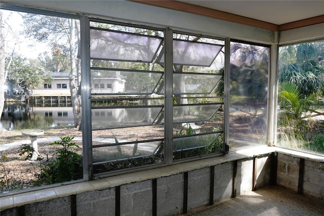 unfurnished sunroom with a water view and a healthy amount of sunlight