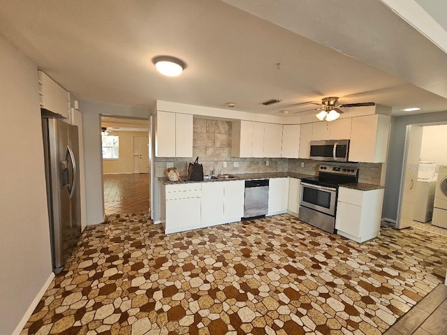 kitchen with a ceiling fan, tasteful backsplash, dark countertops, appliances with stainless steel finishes, and white cabinets