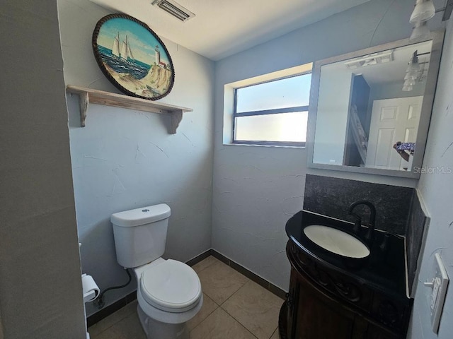 bathroom featuring visible vents, toilet, tile patterned flooring, baseboards, and vanity