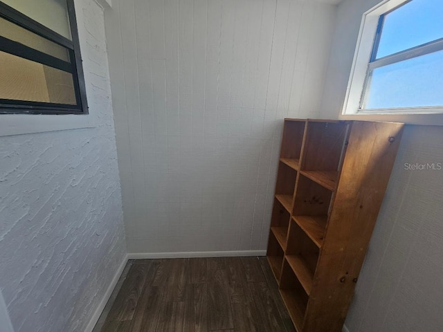 interior space featuring dark wood finished floors and baseboards