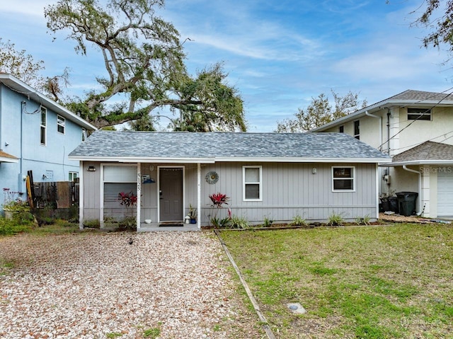 single story home featuring an attached garage, a front lawn, and fence