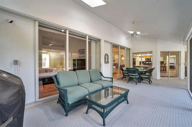 sunroom with lofted ceiling with skylight and ceiling fan