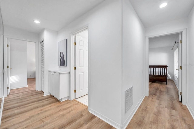 corridor with recessed lighting, visible vents, light wood finished floors, and baseboards