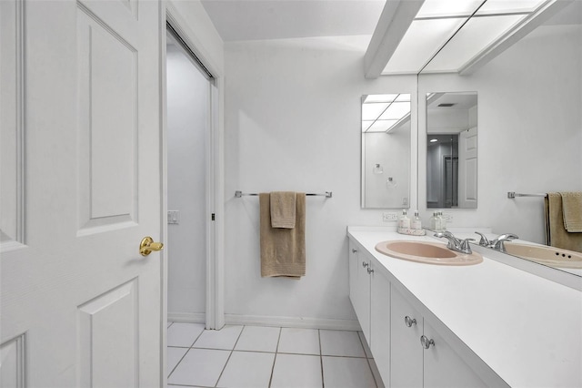 bathroom featuring vanity, tile patterned floors, and baseboards