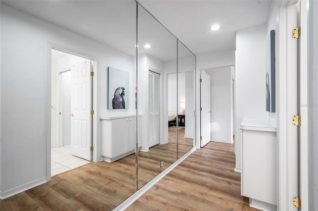 corridor with recessed lighting, baseboards, and wood finished floors