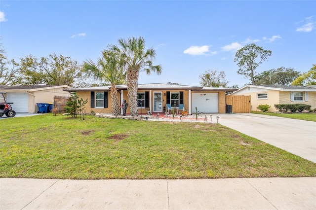 ranch-style home featuring a garage, driveway, a front yard, and fence